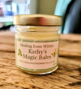 Kathy's Magic Balm in a glass jar, a handmade vegan-friendly multipurpose helbal skin balm
