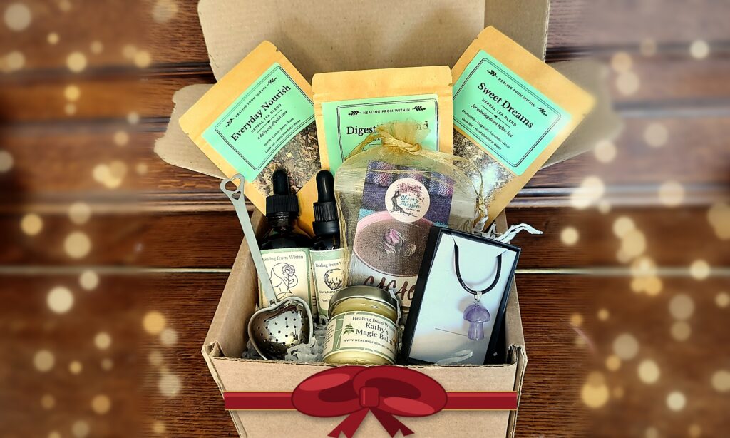 Healing From Within Christmas hamper with mushroom tinctures, three herbal teas, Kathy's Magic Balm, a heart tea strainer, crystal mushroom necklace and cacao